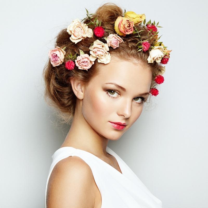 Beautiful woman with flowers. Perfect face skin. Beauty Portrait. Fashion photo